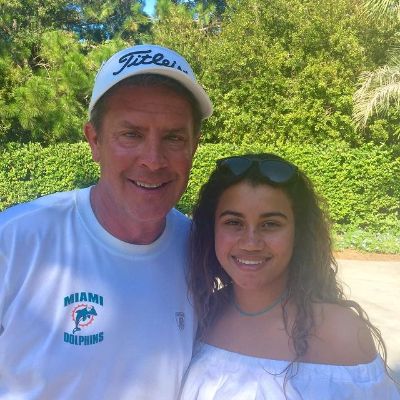 Both Daniella Rose Rucker and Dan Marino are wearing white clothes in the picture.